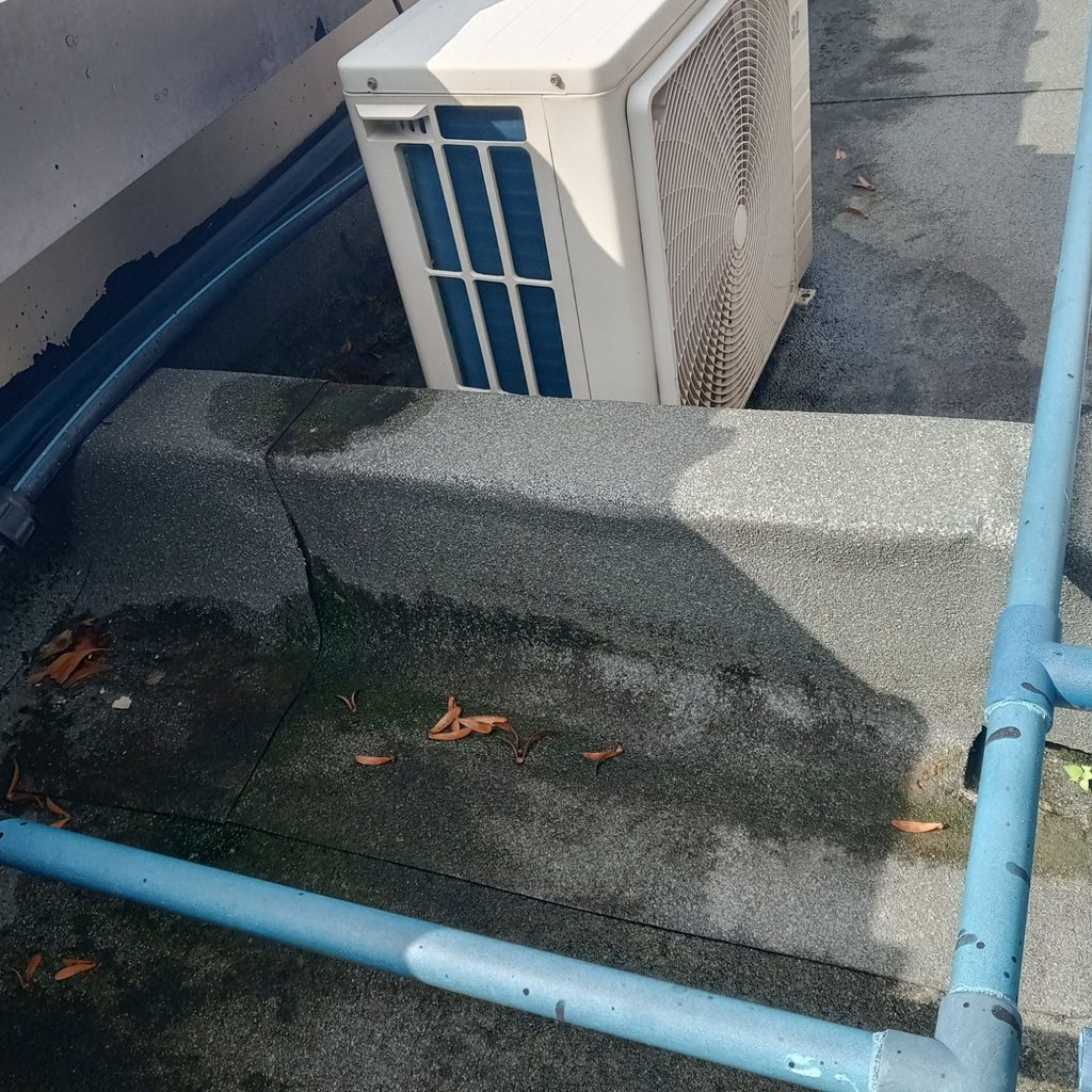 Existing weathered mineral-surfaced waterproofing membrane at the Cascadia roof area before repair work.